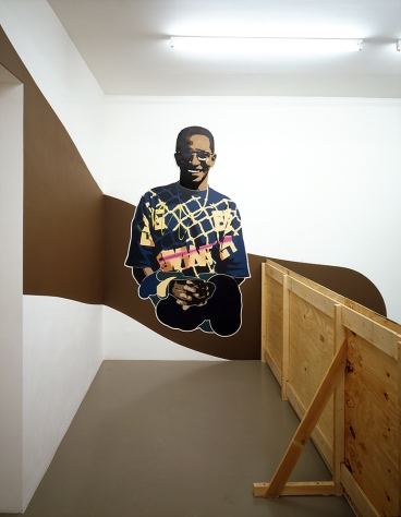 Daniela Brahm Hinterland, 2002 Mirko Mayer Gallery, Cologne “Hiding”, wooden fence, 120 x 750 cm “Participant / Mr. Nguvauva” oil on Forex, cutouts, 240 x 140 cm, emulsion on wall